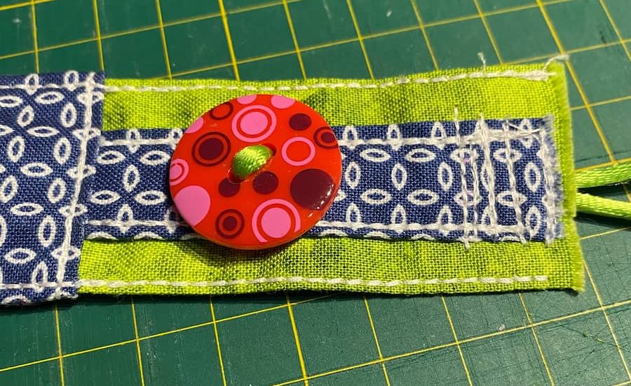 fixation recto cordon pour bouton, front cord attachment for button